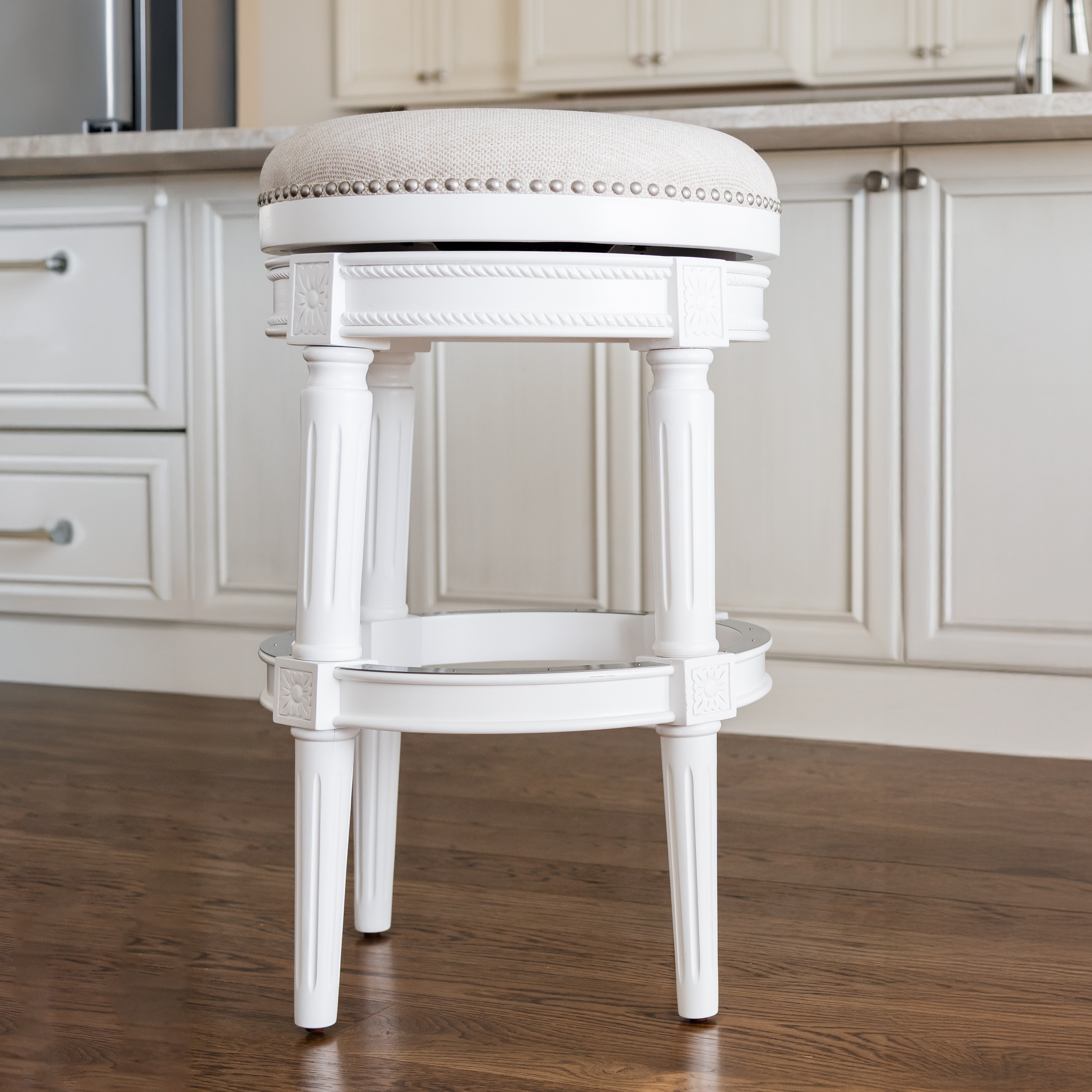 31" Pullman backless swivel bar stool in alabaster white finish with cream fabric upholstery in Stools by Maven Lane