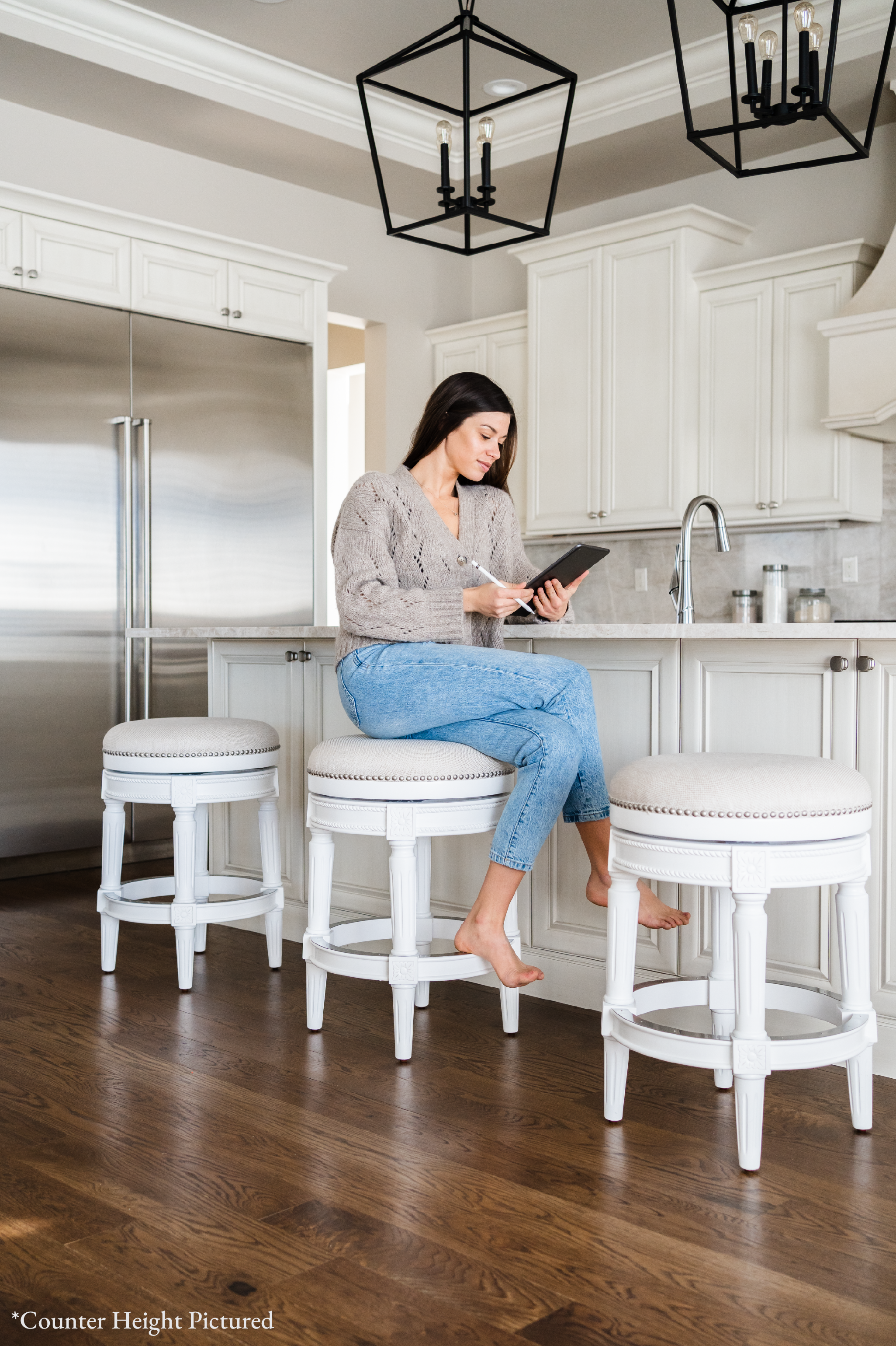 31" Pullman backless swivel bar stool in alabaster white finish with cream fabric upholstery in Stools by Maven Lane
