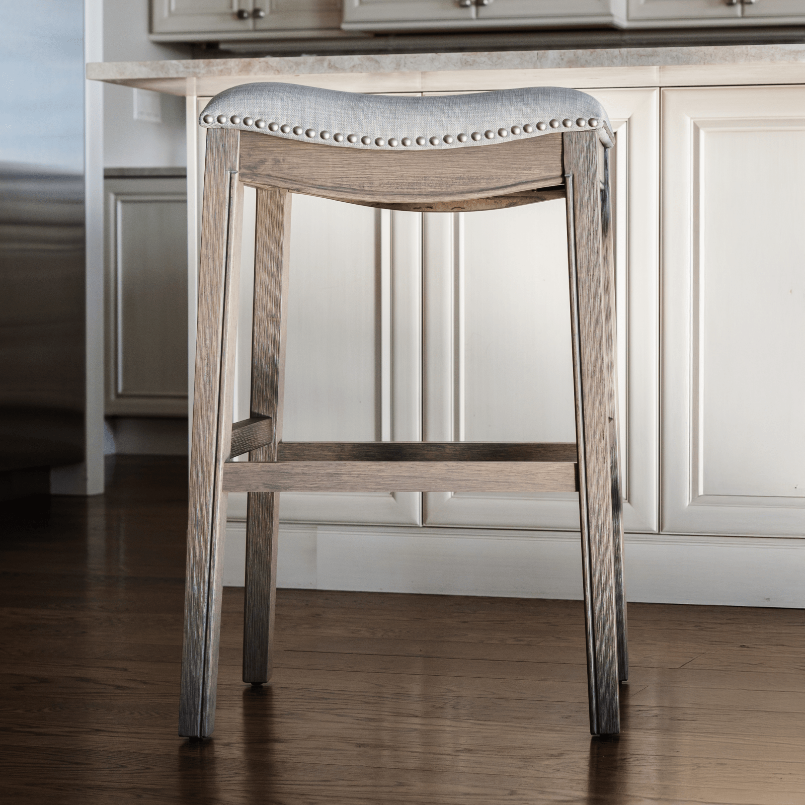 31" Adrien Saddle Bar Stool in Reclaimed Oak Finish with Ash Grey Fabric Upholstery in Stools by Maven Lane