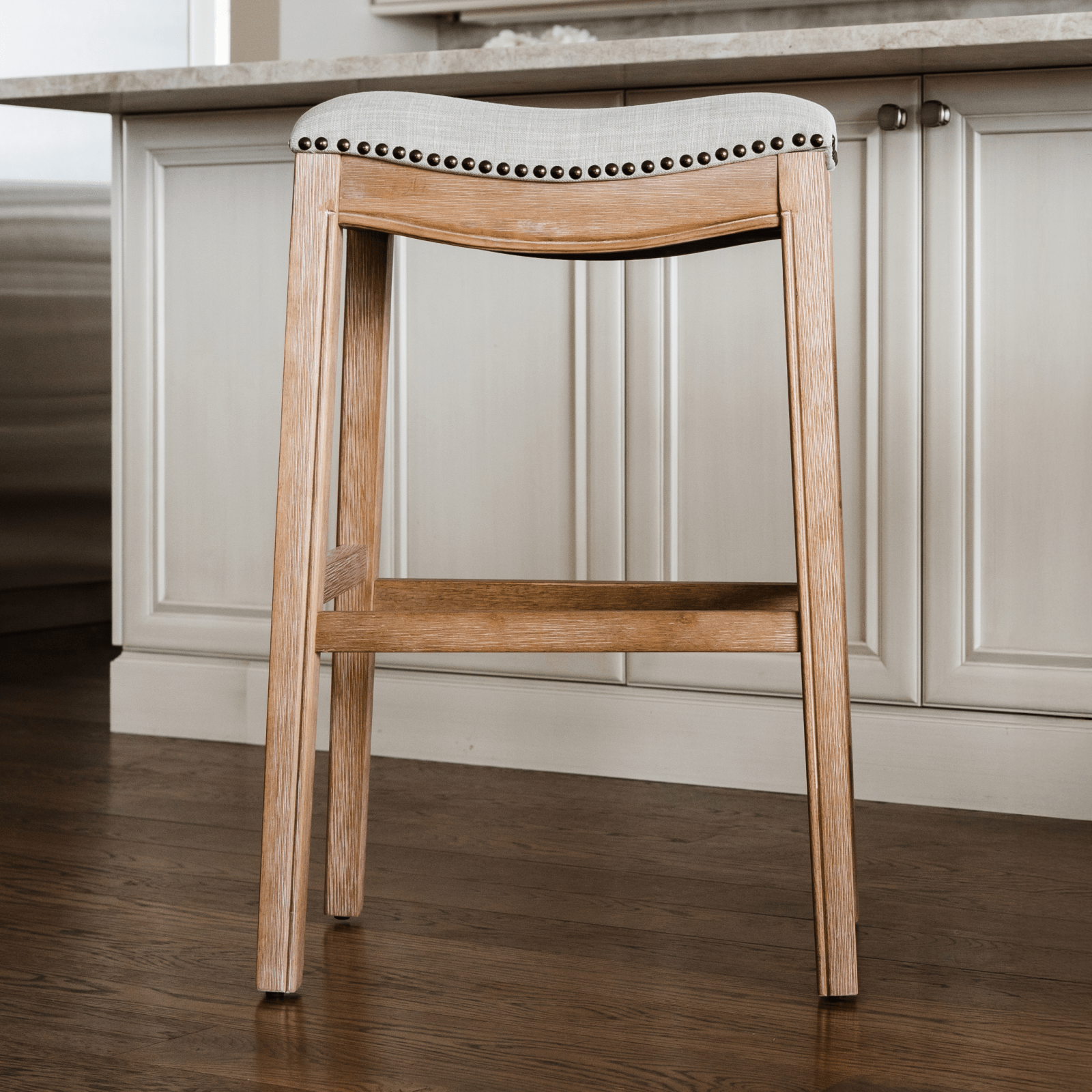 31" Adrien Saddle Bar Stool in Weathered Oak Finish with Sand Color Fabric Upholstery in Stools by Maven Lane