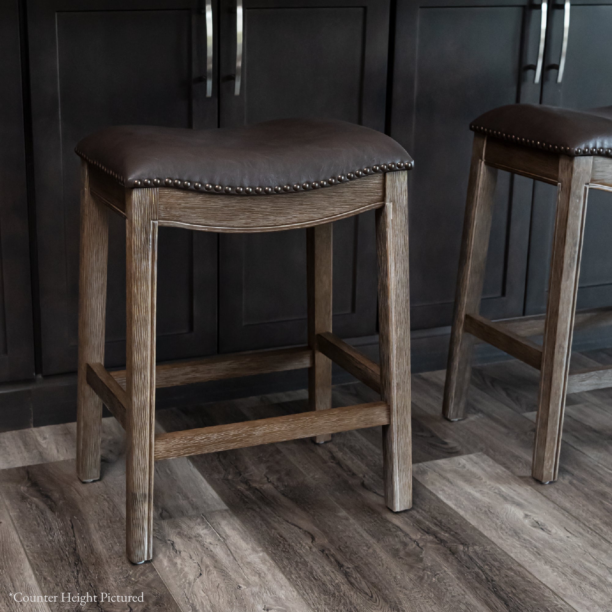 Adrien Saddle Bar Stool in Brown Finish with Dark Brown Faux Leather in Stools by Maven Lane