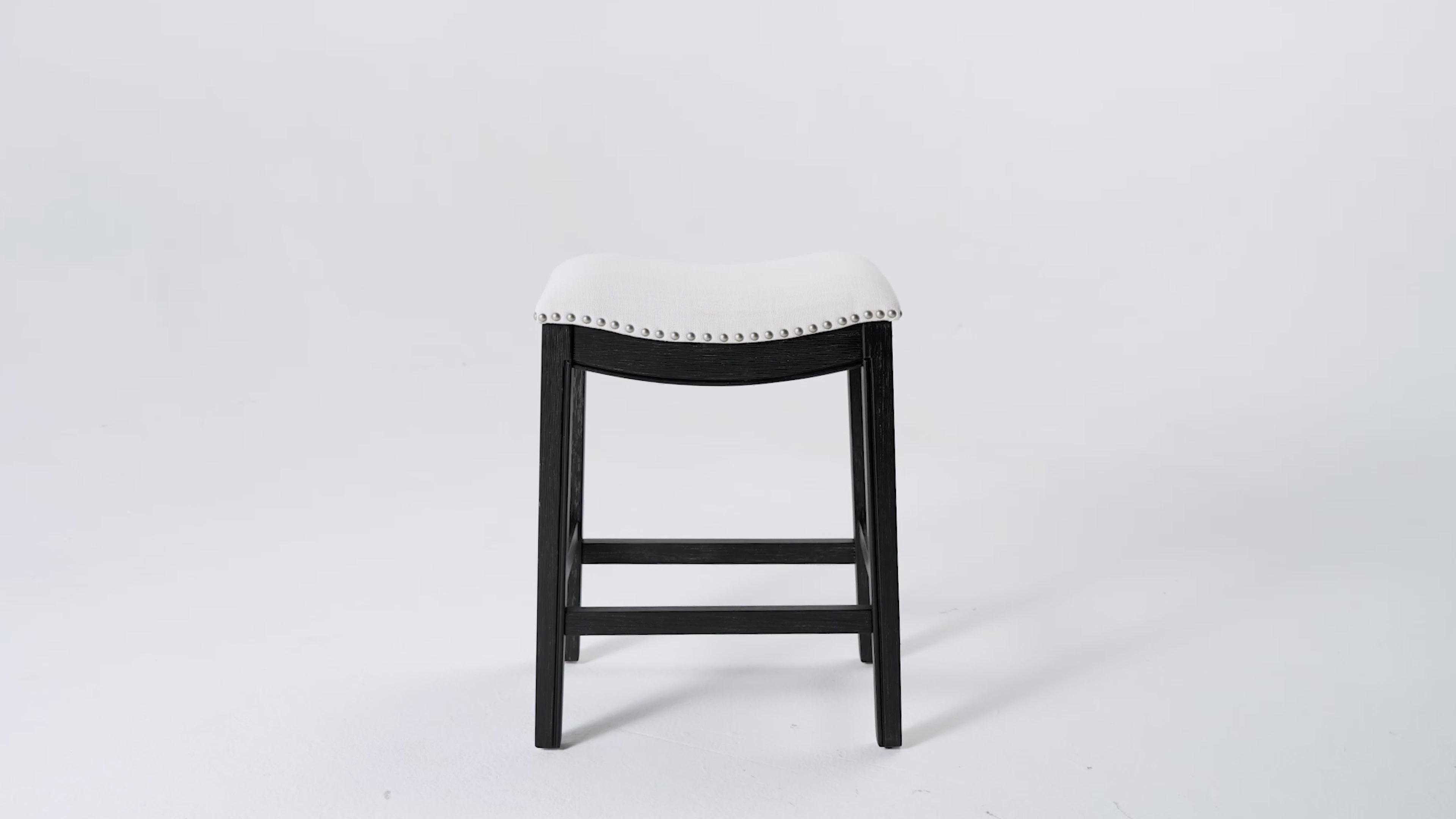 26" Adrien Saddle Counter Stool in Aged Black Finish with Snow White Fabric Upholstery in Stools by Maven Lane