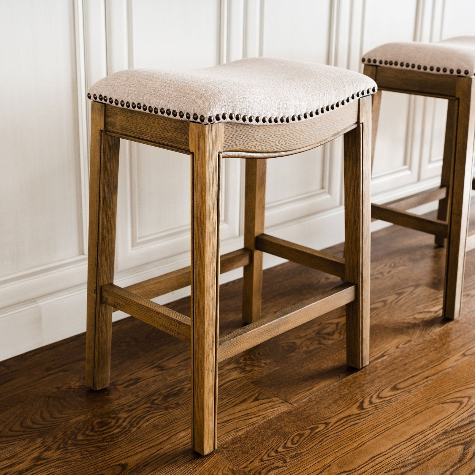 Adrien Saddle Bar Stool in Natural Wood Finish with Wheat Fabric Upholstery in Stools by Maven Lane