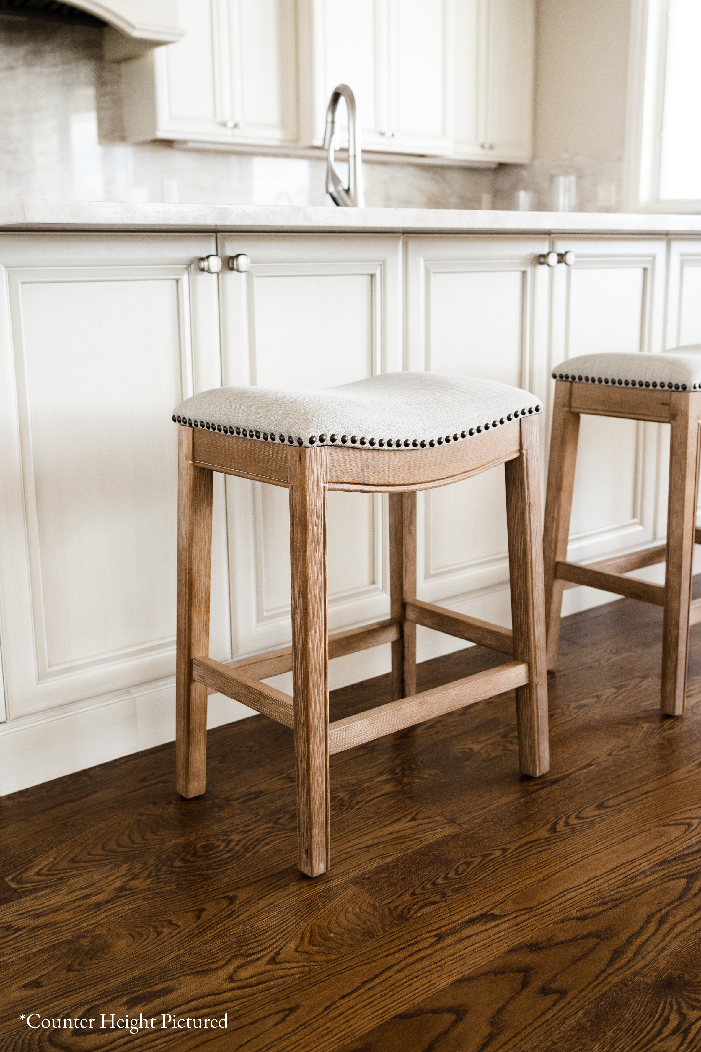 Adrien Saddle Bar Stool In Weathered Oak Finish With Sand Color Fabric Upholstery in Stools by Maven Lane