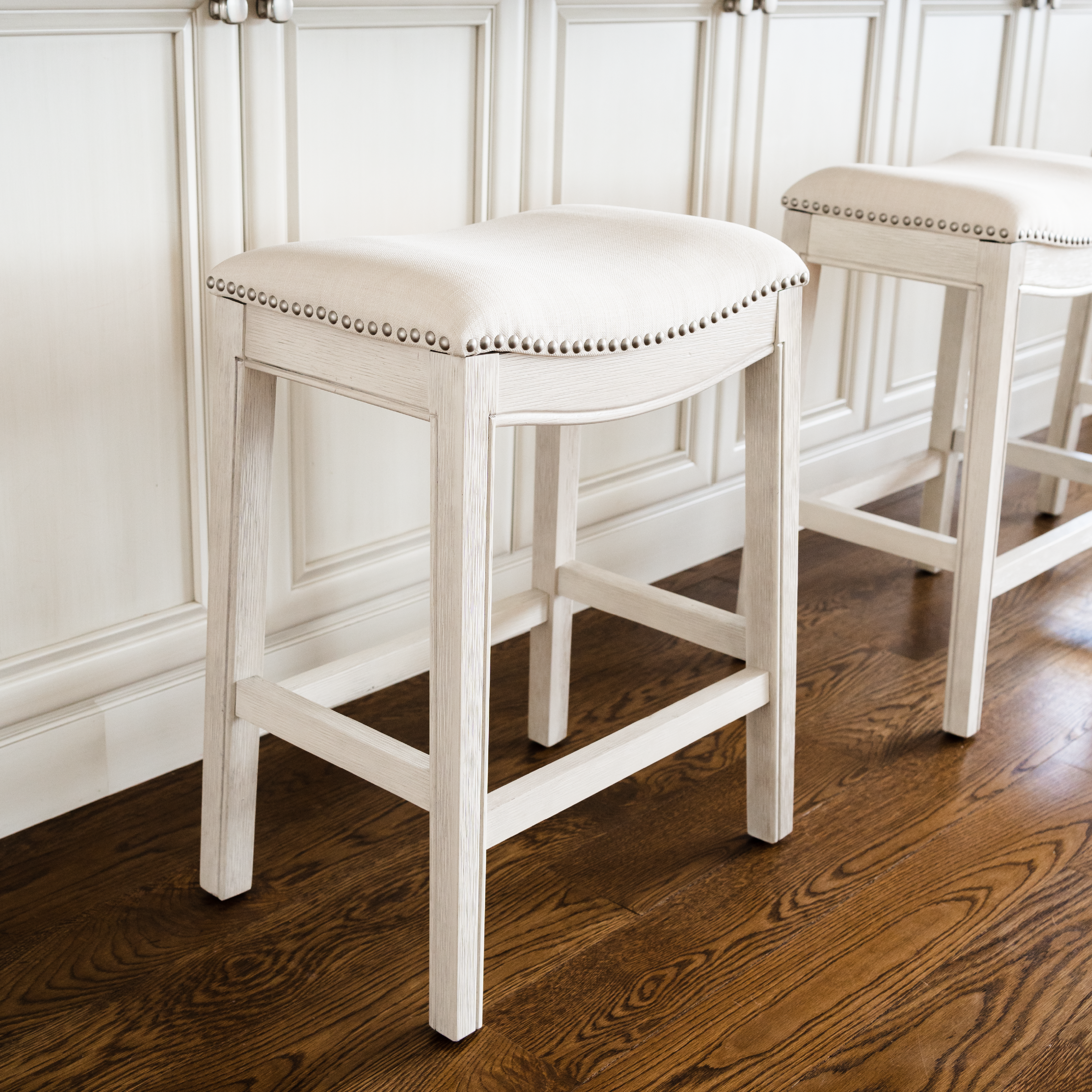 Adrien Saddle Counter Stool In White Oak Finish With Natural Fabric Upholstery in Stools by Maven Lane