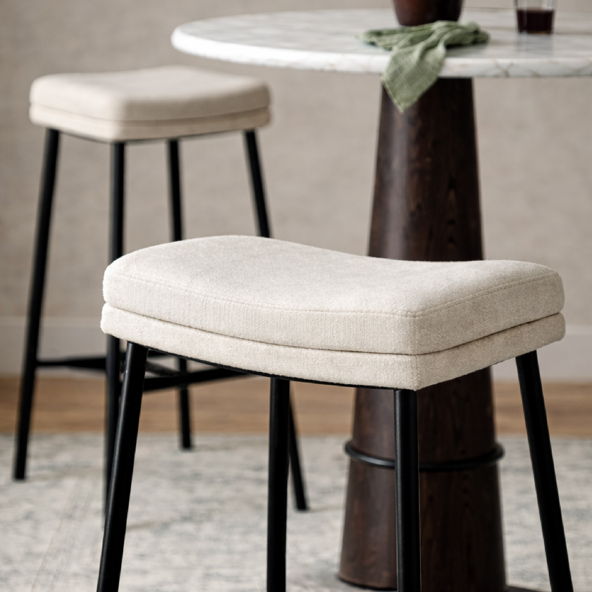 Berkley Bar Height Saddle Stool – Beige Fabric & Matte Black in Maven Lane by Maven Lane