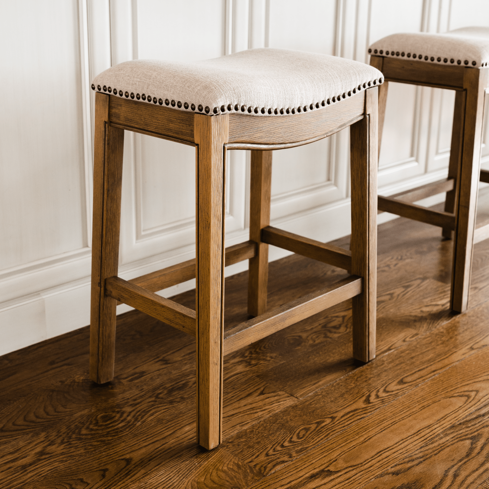 26" Adrien saddle counter height kitchen stool - natural wood finish with wheat fabric upholstery in Stools by Maven Lane