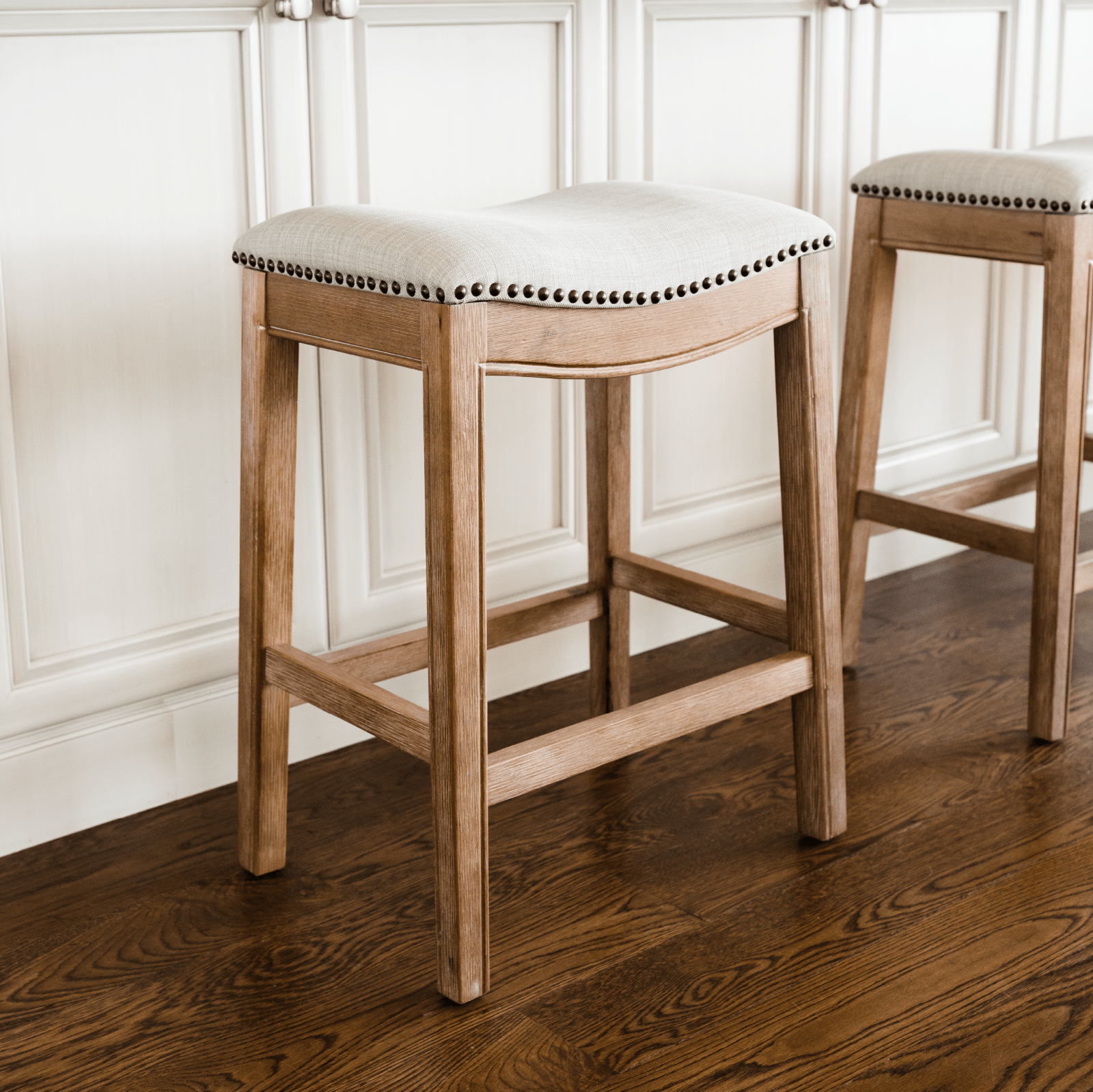 26" Adrien saddle counter height kitchen stool - weathered oak finish with sand color fabric upholstery in Stools by Maven Lane