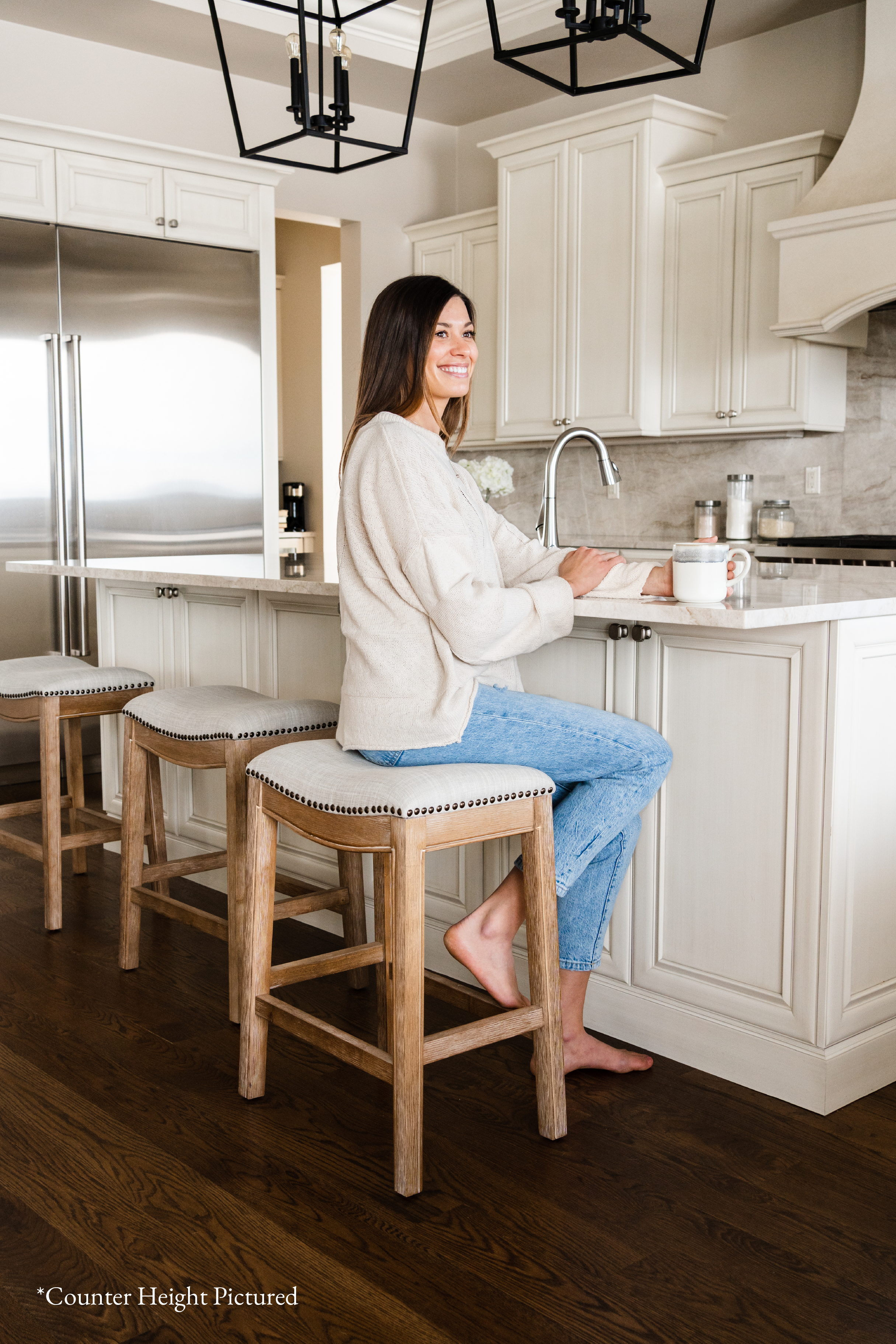 Adrien Saddle Bar Stool In Weathered Oak Finish With Sand Color Fabric Upholstery in Stools by Maven Lane