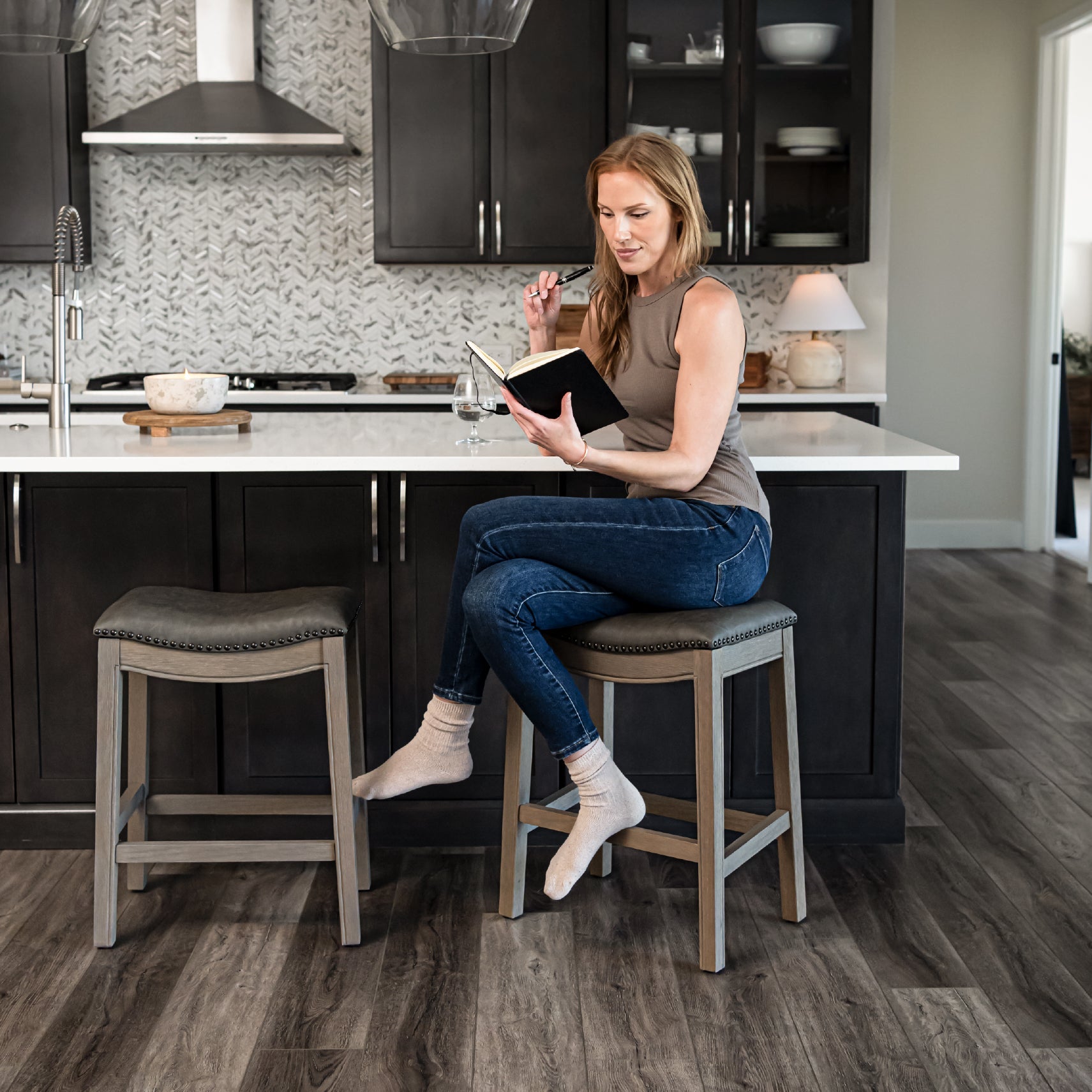 Adrien Saddle Counter Stool in Grey Finish with Grey Faux Leather in Stools by Maven Lane