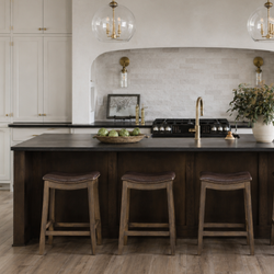Adrien Saddle Counter Stool in Brown Finish with Dark Brown Faux Leather in Stools by Maven Lane