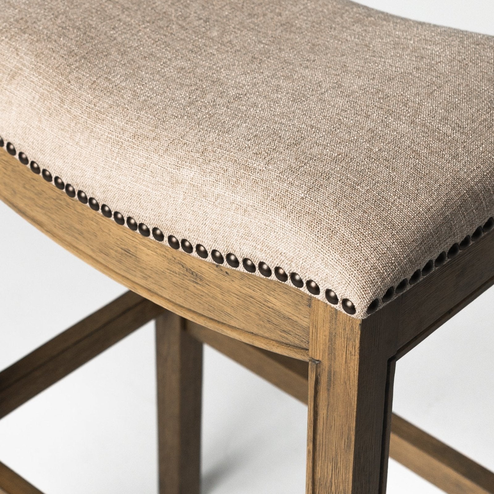 Adrien Saddle Bar Stool in Light Brown Finish and Natural Fabric in Stools by Maven Lane