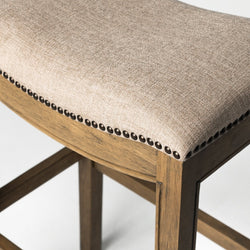 Adrien Saddle Bar Stool in Light Brown Finish and Natural Fabric in Stools by Maven Lane
