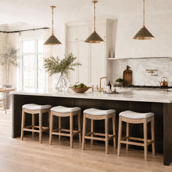 Adrien Saddle Counter Stool in Natural Finish with Light Grey Fabric Upholstery in Stools by Maven Lane