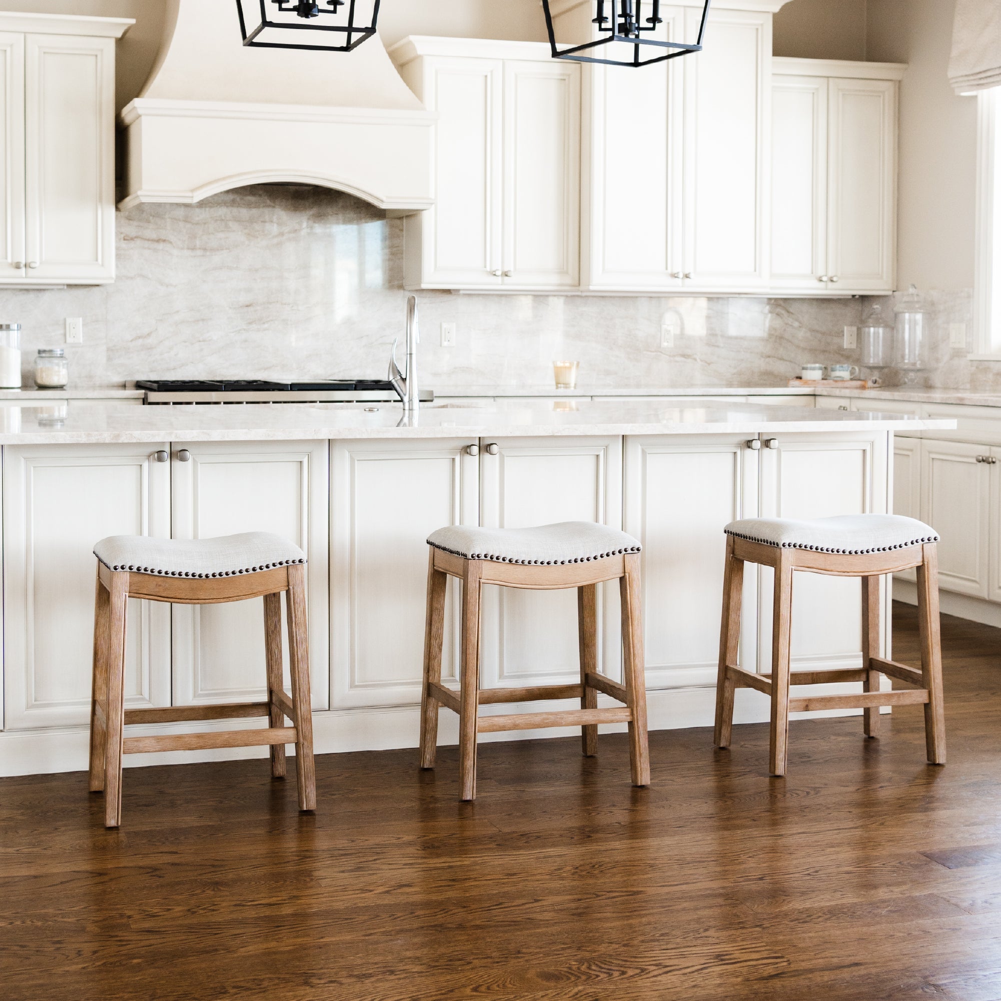 Adrien Saddle Counter Stool in Natural Finish with Light Grey Fabric Upholstery in Stools by Maven Lane