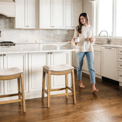 Adrien Saddle Counter Stool in Light Brown Finish and Natural Fabric Upholstery in Stools by Maven Lane
