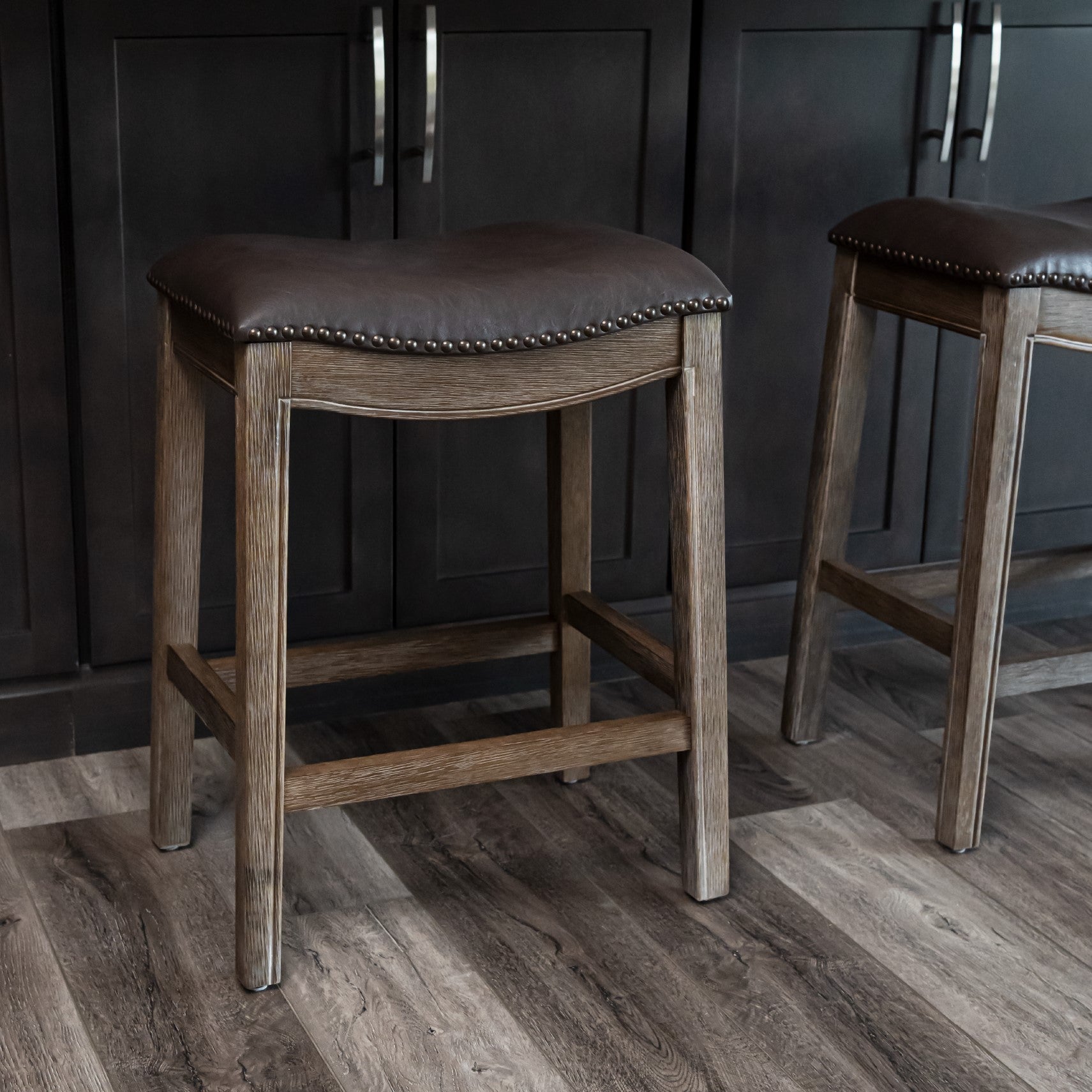Adrien Saddle Counter Stool in Brown Finish with Dark Brown Faux Leather in Stools by Maven Lane