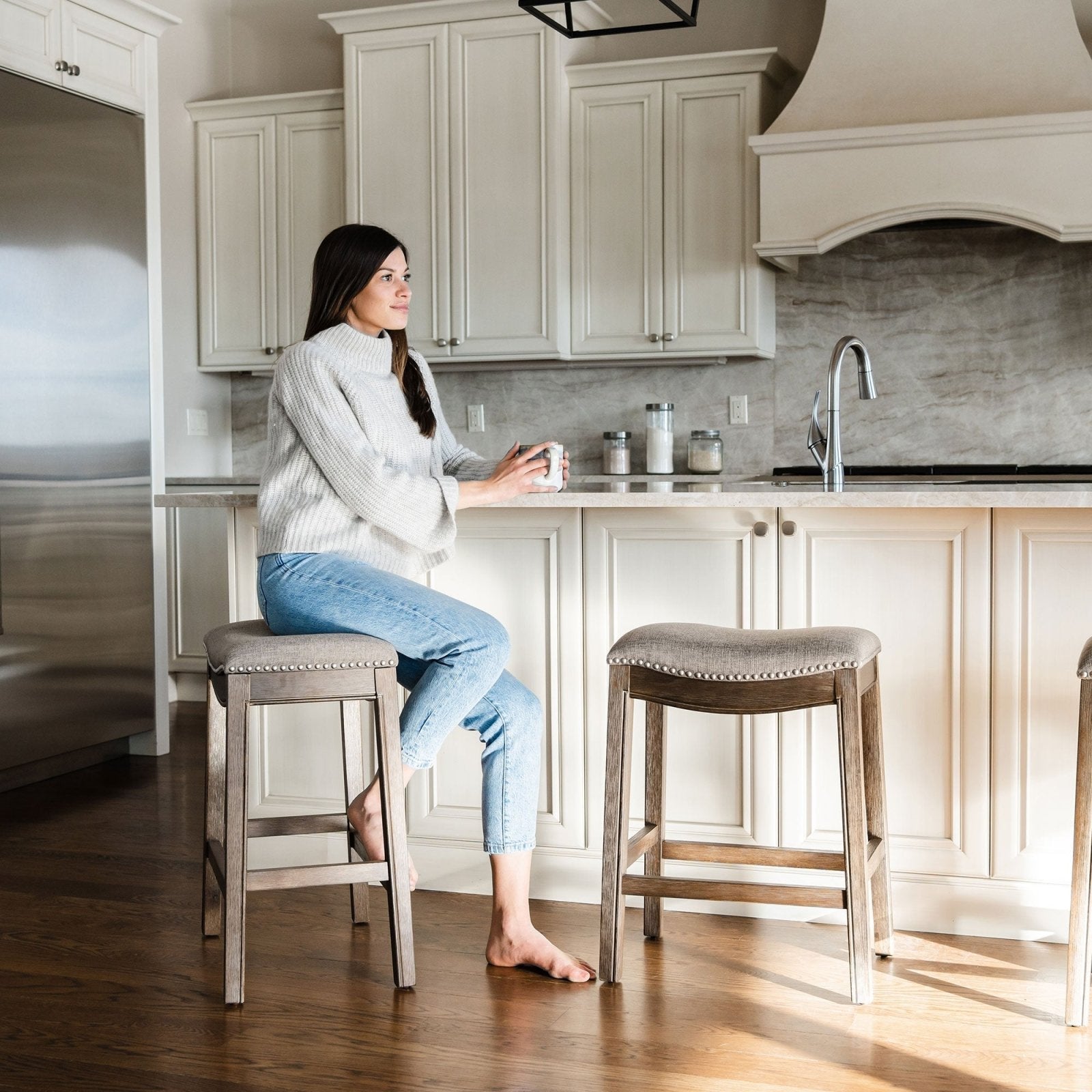 Adrien Saddle Bar Stool in Walnut Finish with Grey Fabric Upholstery in Stools by Maven Lane