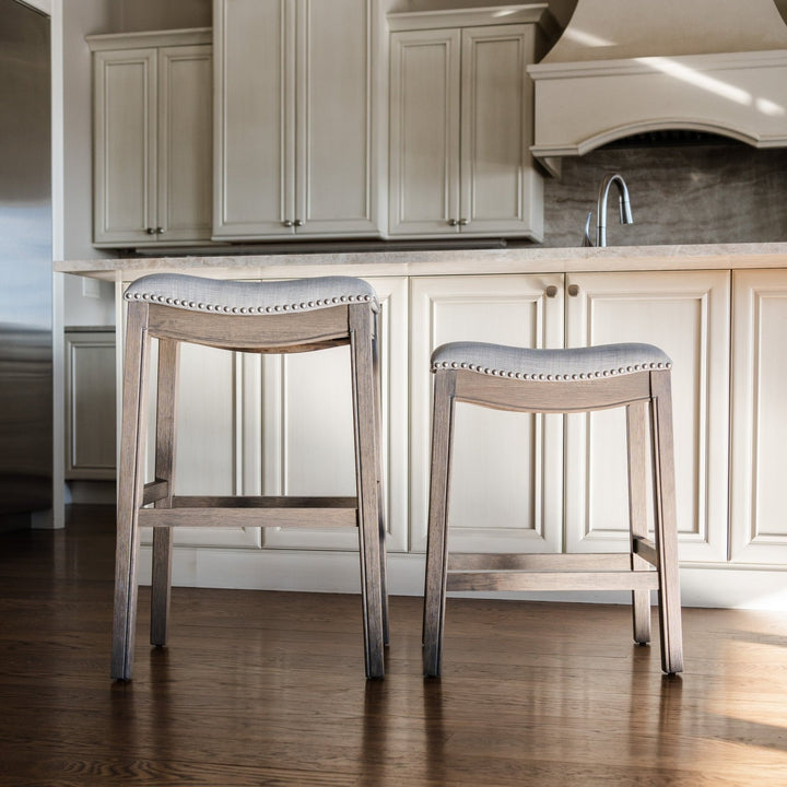 Adrien Saddle Counter Stool In Reclaimed Oak Finish With Ash Grey Fabric Upholstery in Stools by Maven Lane