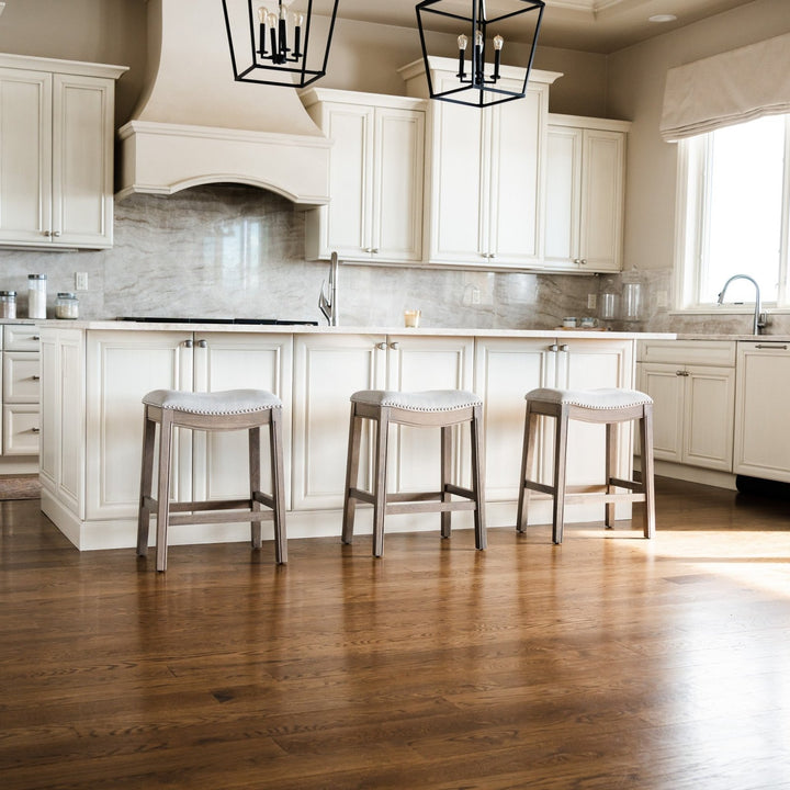 Adrien Saddle Counter Stool In Reclaimed Oak Finish With Ash Grey Fabric Upholstery in Stools by Maven Lane