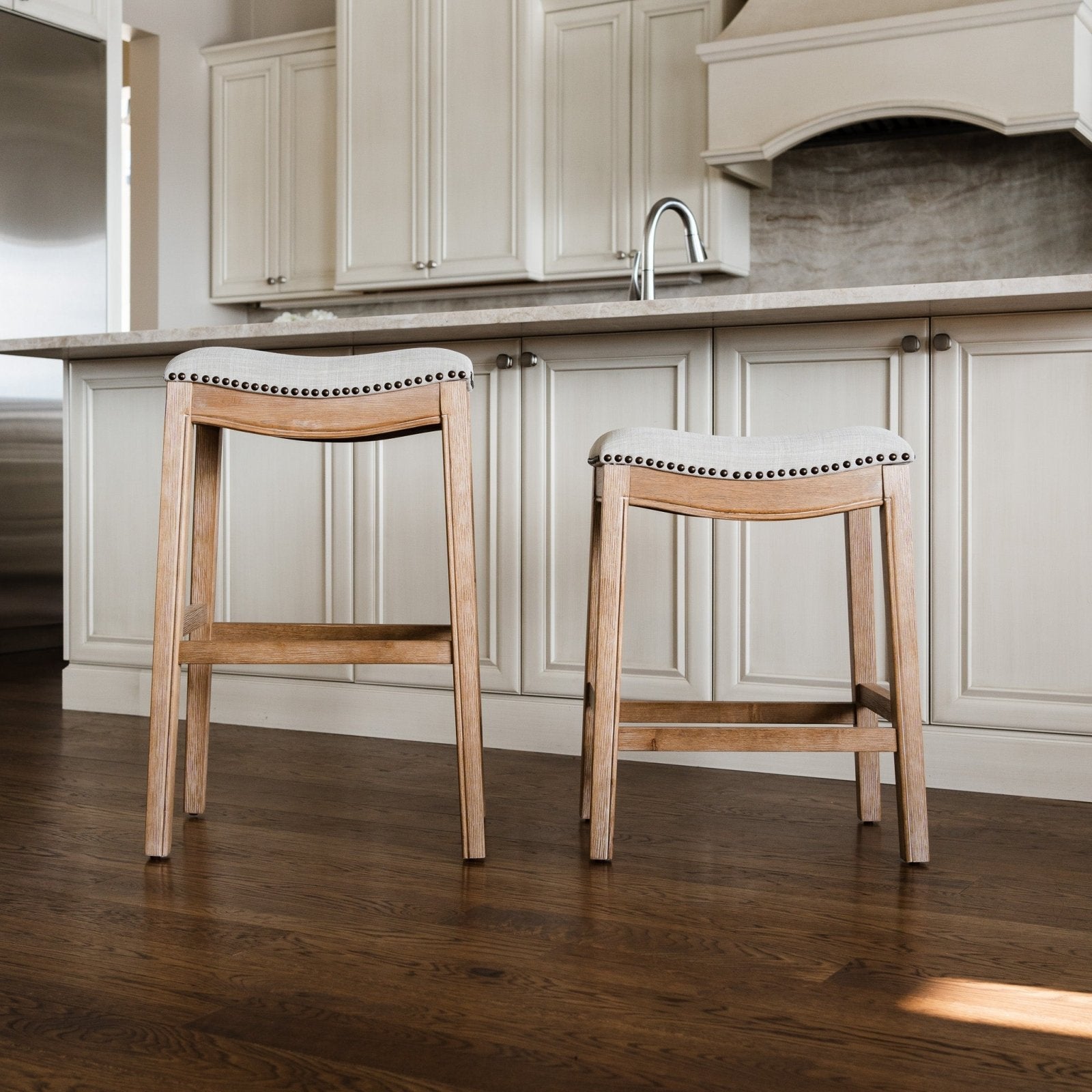 Adrien Saddle Counter Stool In Weathered Oak Finish With Sand Color Fabric Upholstery in Stools by Maven Lane