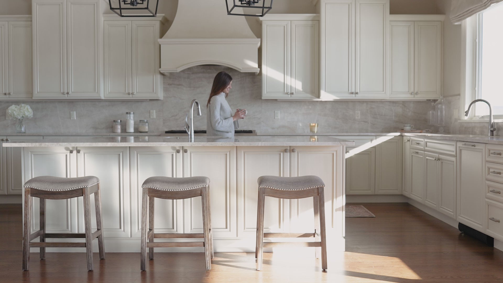 Adrien Saddle Bar Stool in Walnut Finish with Grey Fabric Upholstery in Stools by Maven Lane