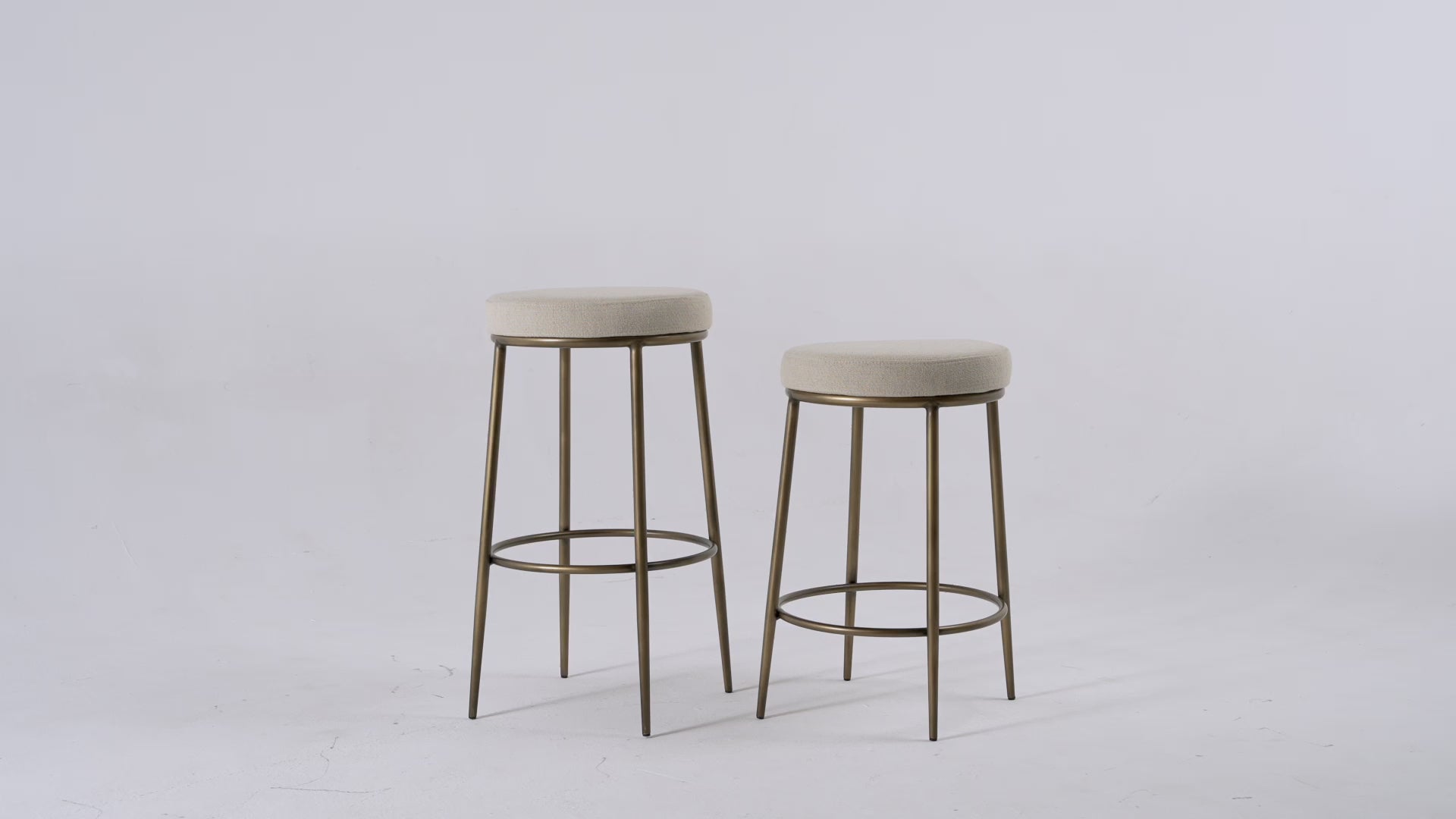 Stella Bar Stool In Antique Brass Finish With Light Beige Fabric Upholstery in Stools by Maven Lane