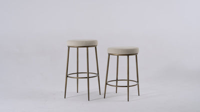 Stella Bar Stool In Antique Brass Finish With Light Beige Fabric Upholstery in Stools by Maven Lane