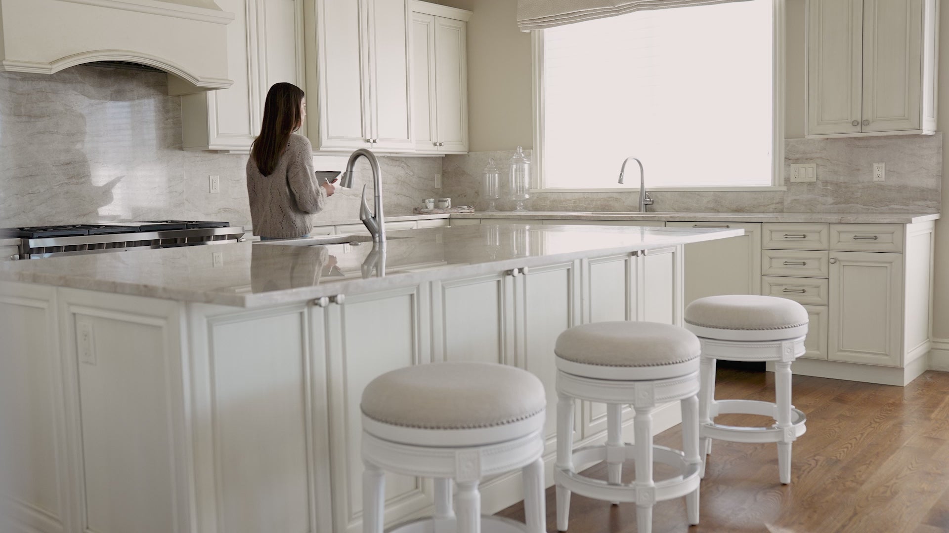 31" Pullman backless swivel bar stool in alabaster white finish with cream fabric upholstery in Stools by Maven Lane