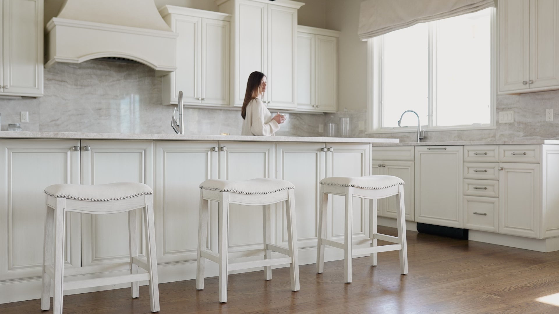 Adrien Saddle Bar Stool In White Oak Finish With Natural Fabric Upholstery in Stools by Maven Lane