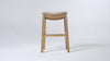 Adrien Saddle Bar Stool in Light Brown Finish and Natural Fabric in Stools by Maven Lane